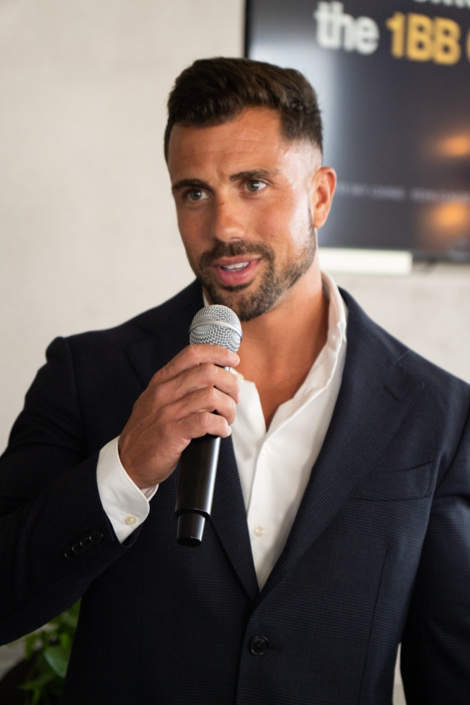 Teaching on the microphone at the launch party